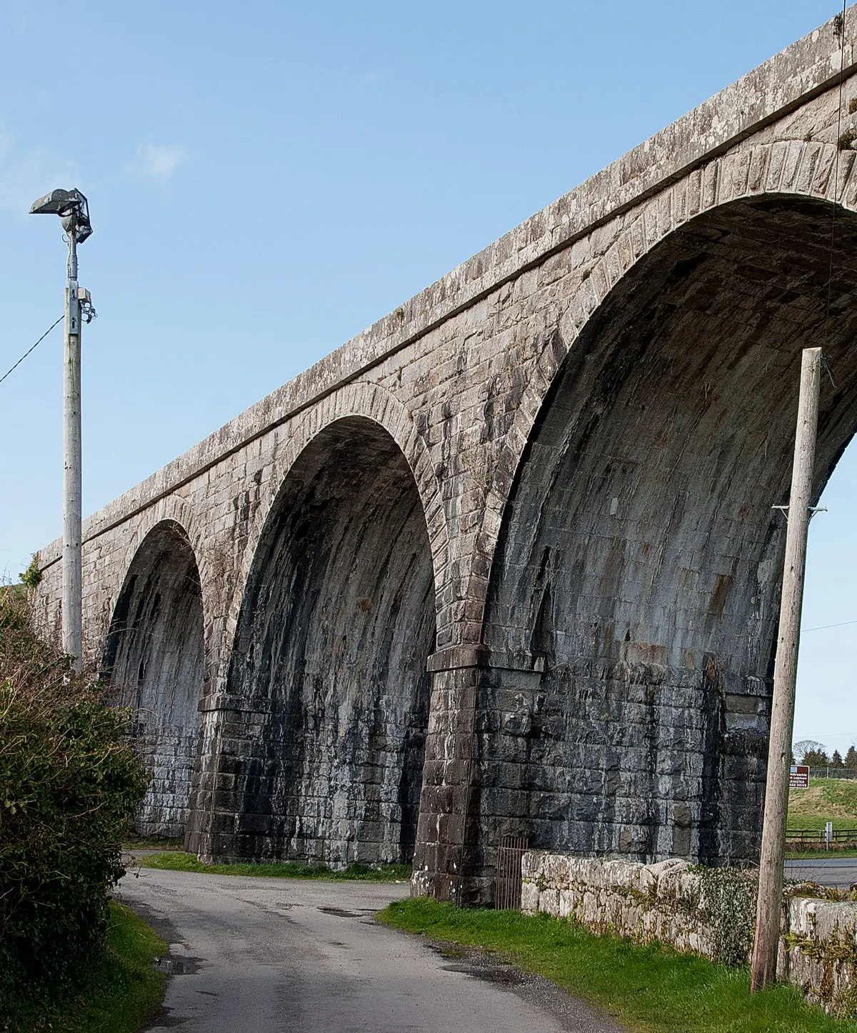 Borris viaduct, its limestone arches receding above a country lane, part of the sixteen-arch railway viaduct across the valley