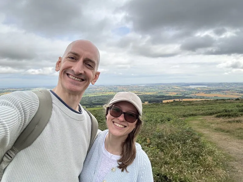 Niall and Rita Doherty on a hillside walk, with farmland stretching out behind them